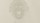 A faint, grayscale image of a classical statue’s face with soft features and minimal details visible against a plain background.