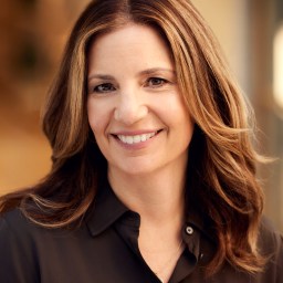 A smiling woman in a black shirt.