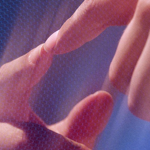 A person's hand is interacting with a blue screen.