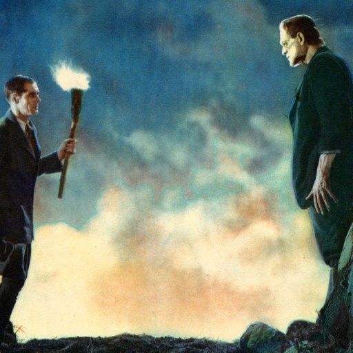 Two men standing on top of a mountain with a torch.