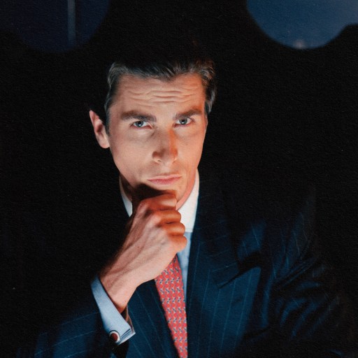 An alpha male in a suit sitting in a chair.