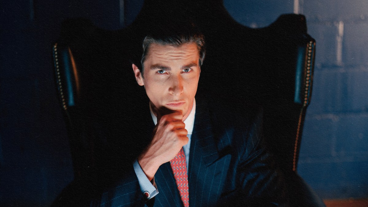 An alpha male in a suit sitting in a chair.