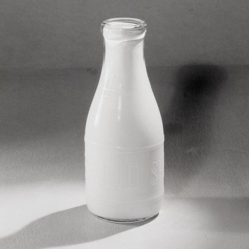 An image of a bottle of milk with bacteria on it.