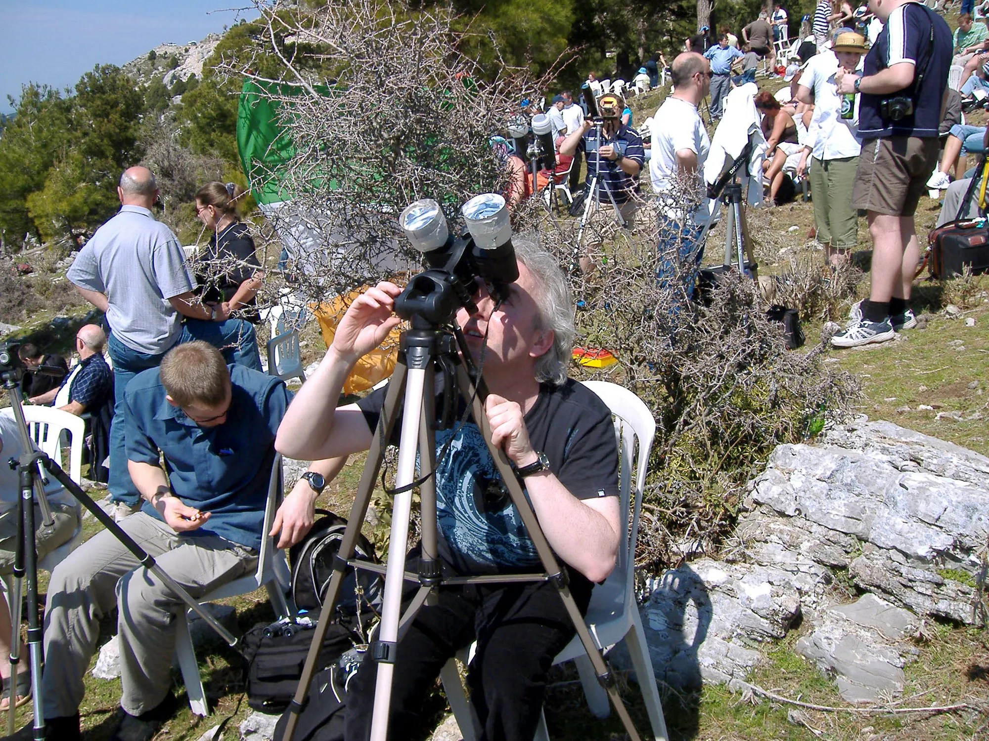 woman tripod eclipse binoculars solar filter