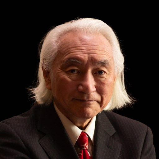 A man in a suit with white hair and a red tie.