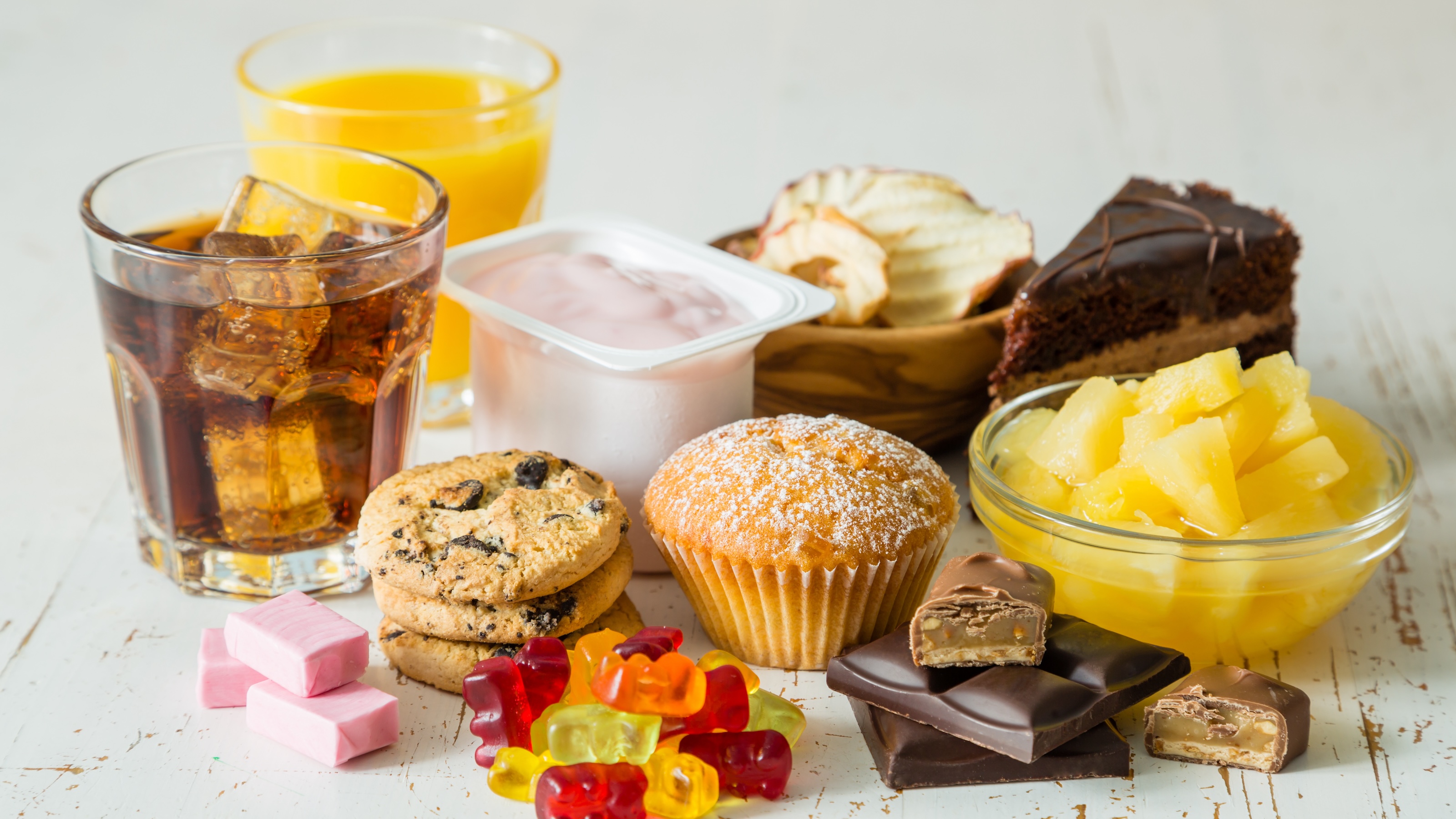 A variety of fructose-rich foods and drinks on a table.