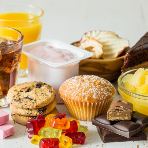 A variety of fructose-rich foods and drinks on a table.