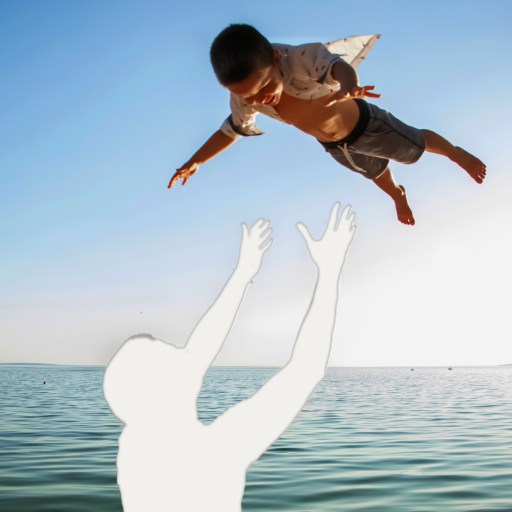 A silhouette of a boy jumping into the water.