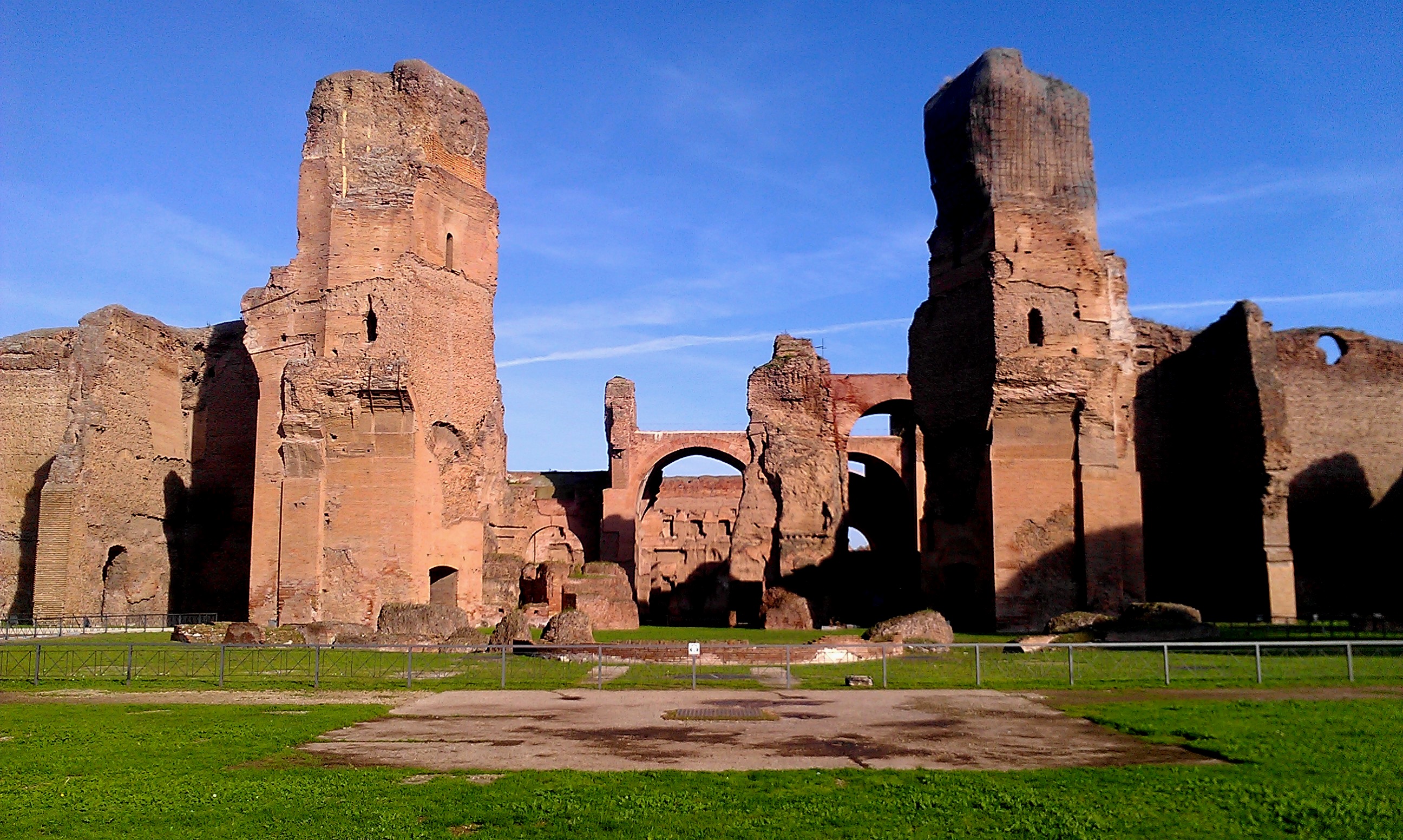 Keywords: group, ruins
Description: A group of ancient Roman ruins in the middle of a grassy field.