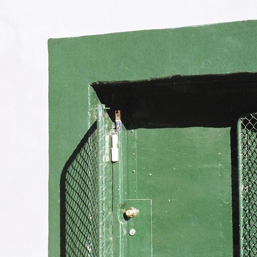 A man sitting on a bench in front of a startup exit door.
