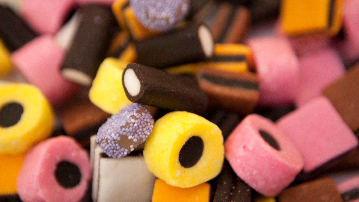 A close up of a pile of different colored candies, including one or two varieties infused with ammonium chloride.