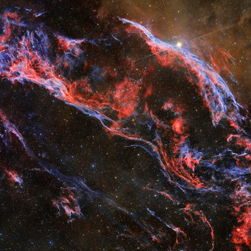 An image showcasing the captivating shape of space featuring a mesmerizing red and blue nebula.