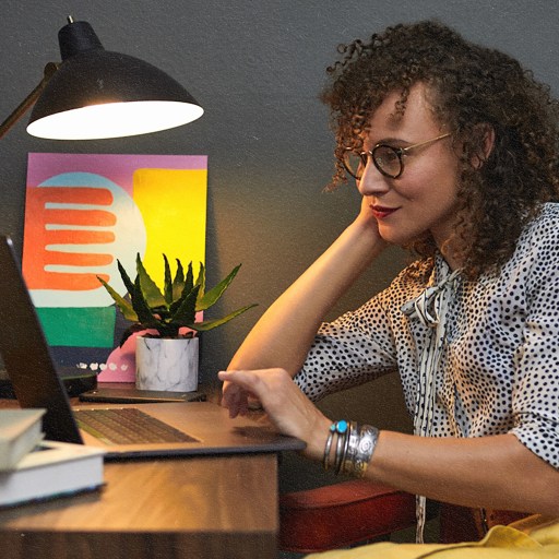 A woman making the best decisions at a desk with a laptop.