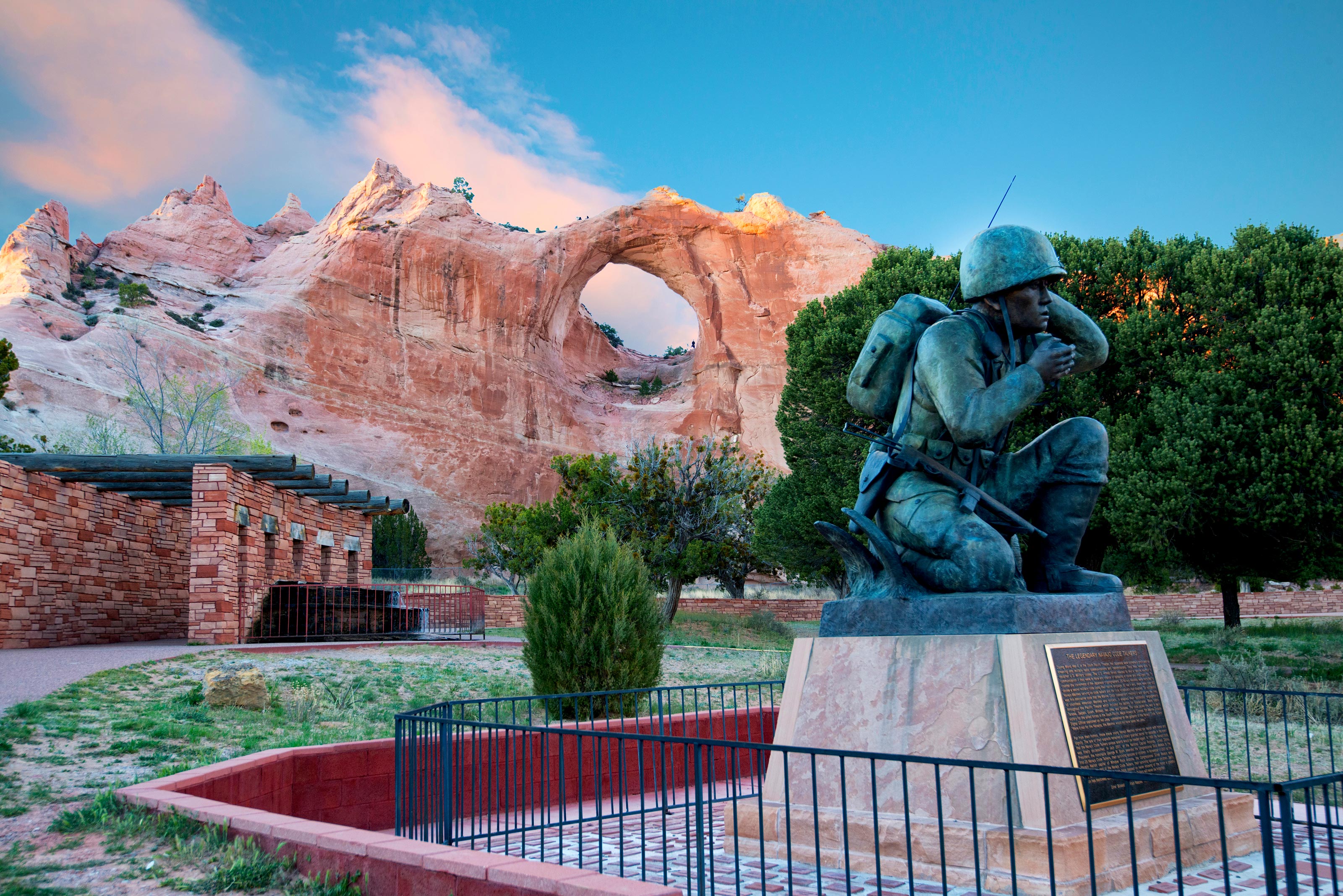 A Navajo soldier statue in front of a rock formation.