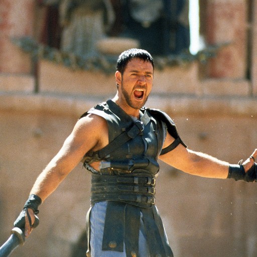 A gladiator brandishing a sword amidst a crowd.