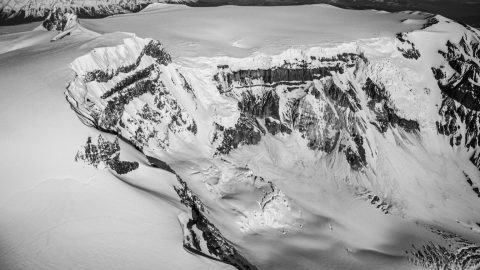 A black and white photo of a snow covered mountain.