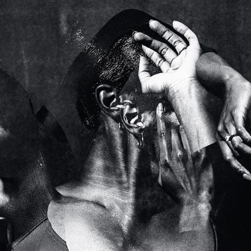 A black and white photo of a man with his hands on his head.