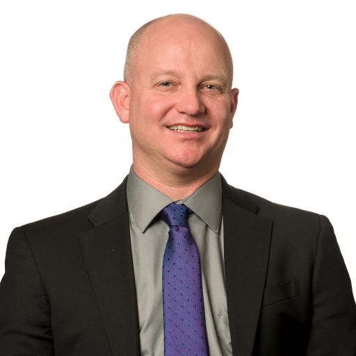 A bald man in a suit and tie.