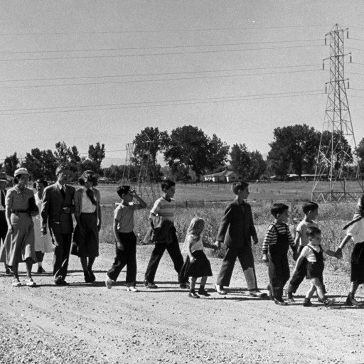 A family walking down a dirt road.
