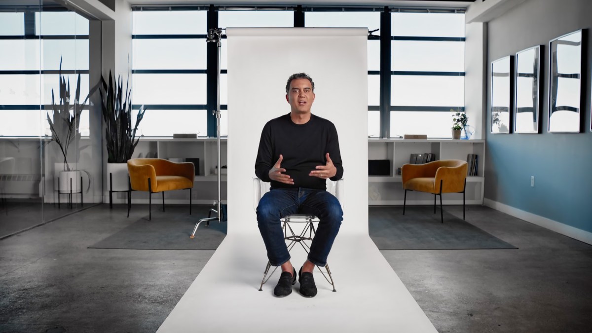 Emil Michael sitting on a chair in an office.