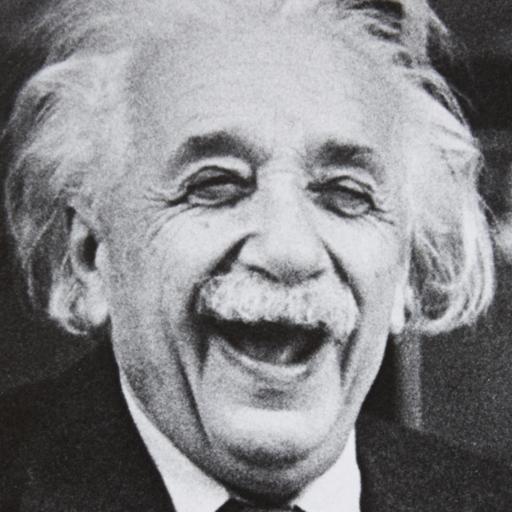 A black and white photo of albert einstein laughing.
