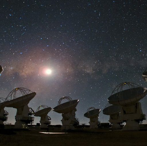 A group of satellite dishes under a starry sky, capturing celestial signals from star birth.