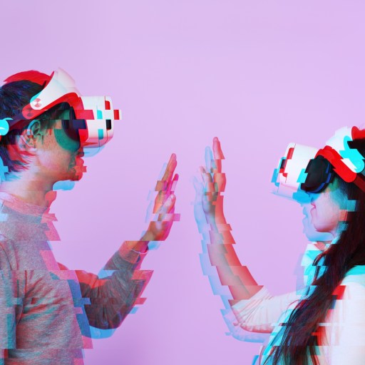 A man and woman wearing a vr headset and giving each other a high five.