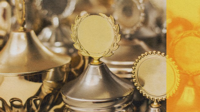 A group of gold trophies showcasing too much talent on a table.
