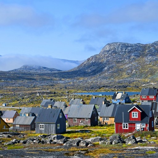 A cluster of vibrant houses perched on a mountainside, offering a sense of life satisfaction.