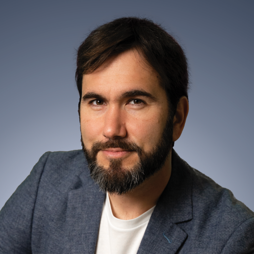 A man with a beard and a white shirt.
