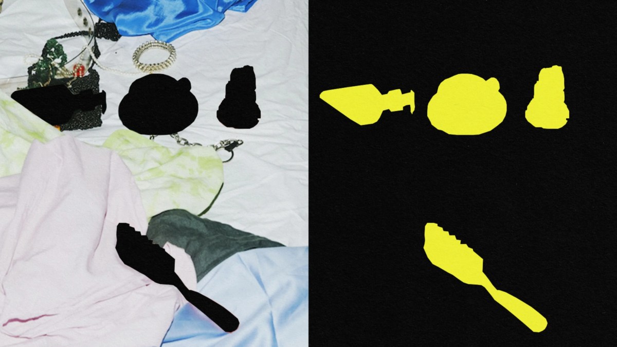 A black and white photo of clothes and a yellow spoon on a bed.