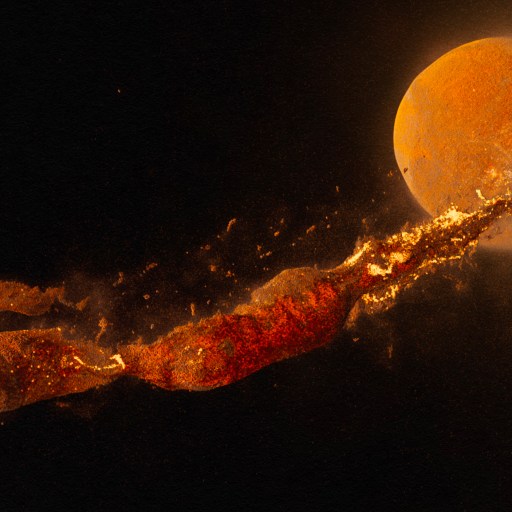 An image of a fireball emerging from a dark background.