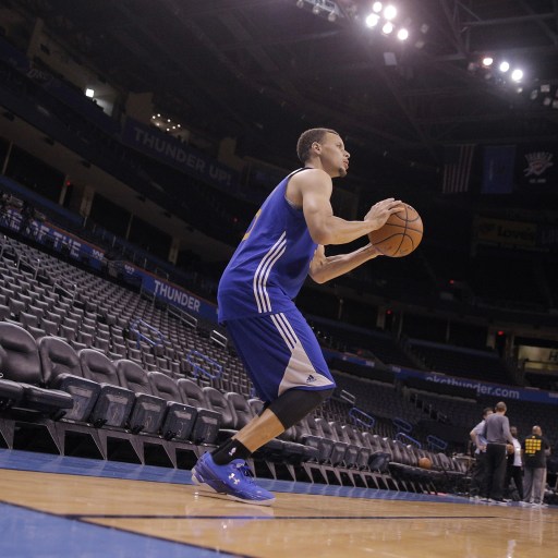 A man in a blue jersey holding a basketball participates in sports psychology.