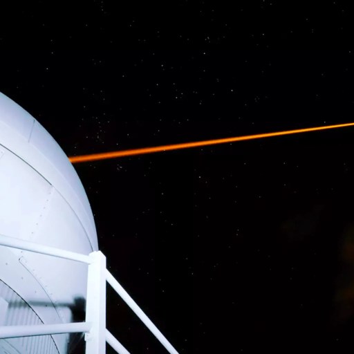 A laser beam is coming out of a large dome.