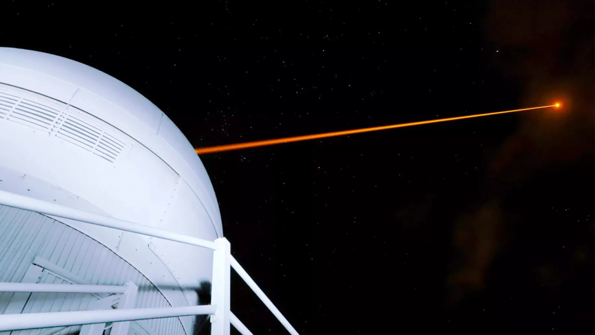 A laser beam is coming out of a large dome.