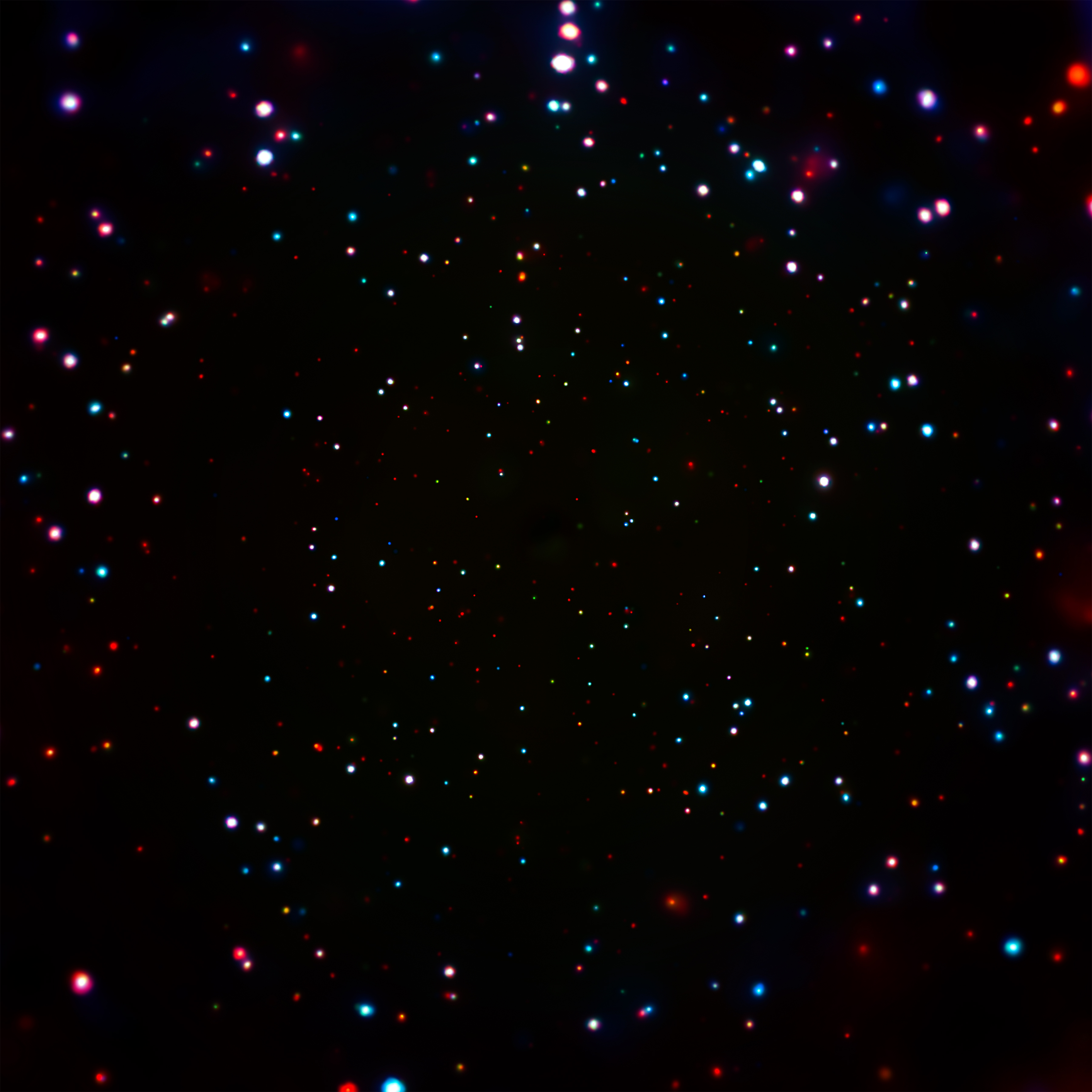 Colorful bokeh lights scattered across a dark background, resembling a starry night sky captured by a space telescope.