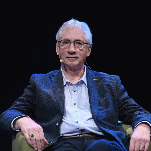 Man sitting on a chair on stage during a Frans de Waal event.