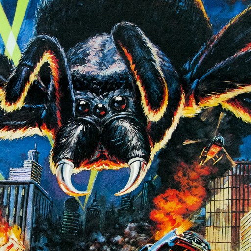 Artwork of a giant spider attacking a city, with buildings in flames and text in japanese.
