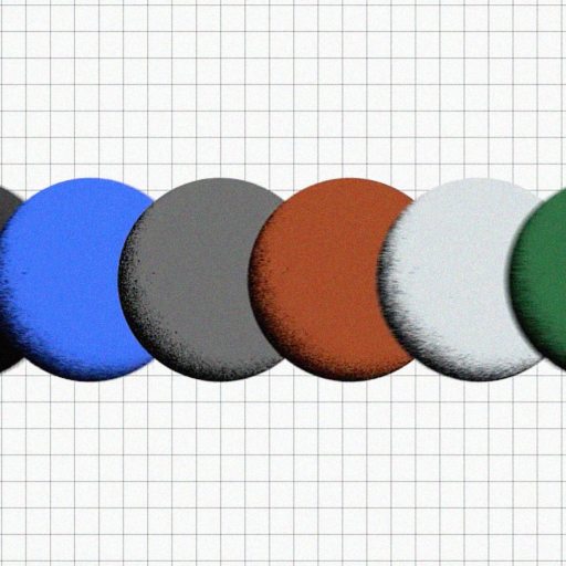 Five round, flat objects in black, blue, gray, red, and green are arranged in a row on a grid background.