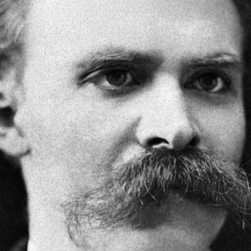 Black and white portrait of a man with a thick mustache and short hair, looking slightly to the side.