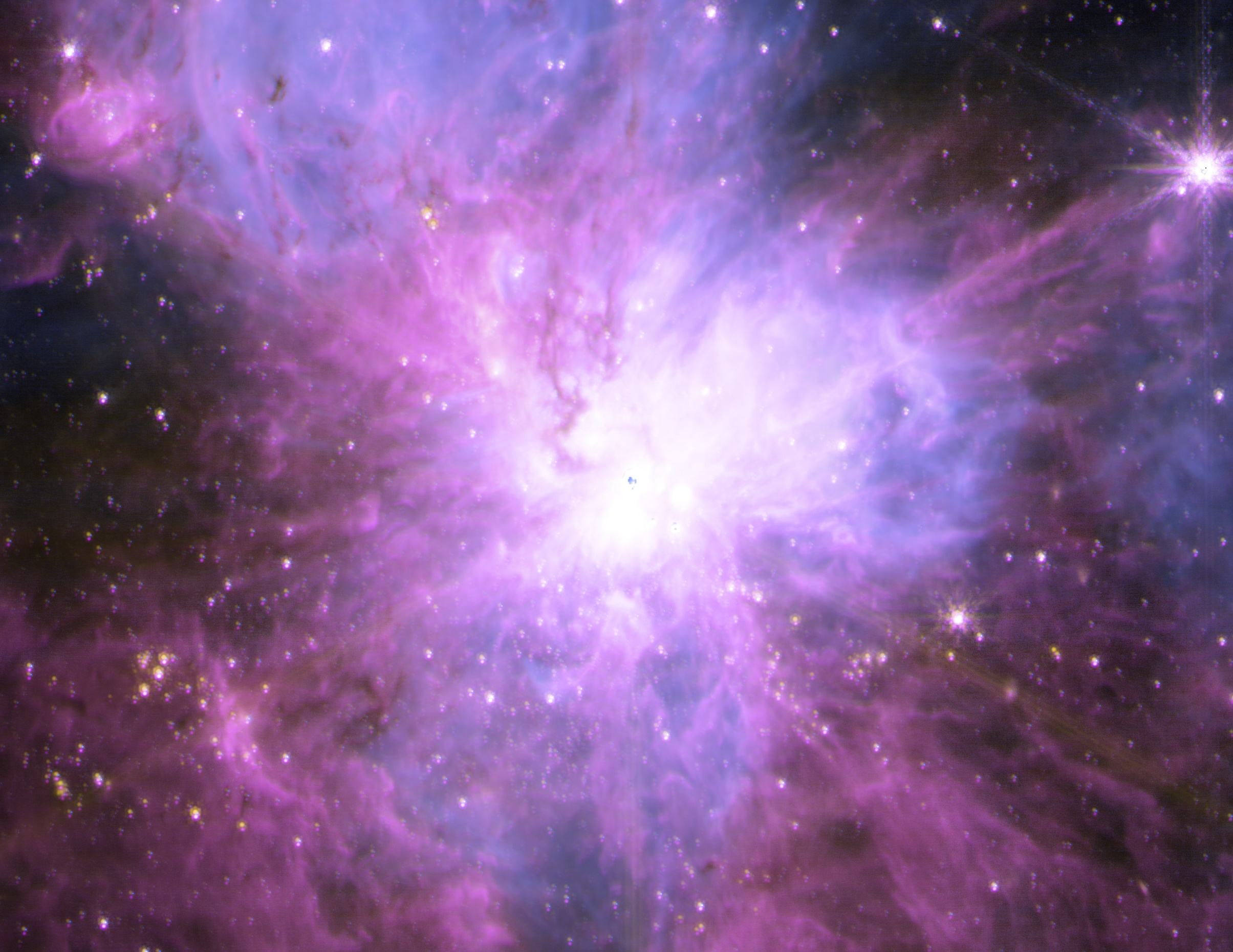 A vibrant cosmic nebula with swirling purple and pink gases, illuminated by a bright white center, is nestled within a super star cluster, set against a backdrop of distant stars in space.