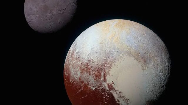 Image of Pluto and its moon Charon in space. Pluto shows distinct surface features with areas of varying colors, while Charon appears smaller with a darker, smoother surface.