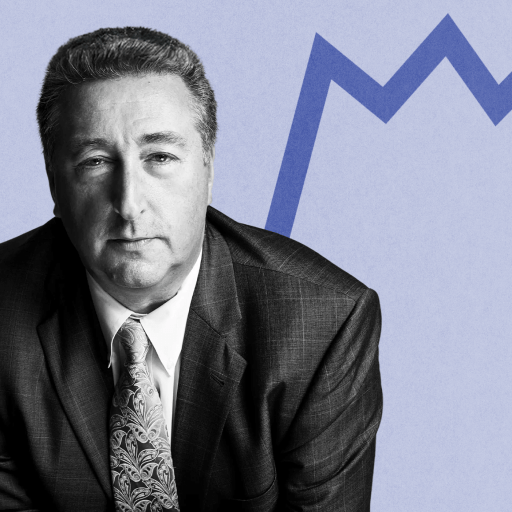 Barry Ritholtz, a man in a suit and tie, stands confidently before a blue zigzag line on a light backdrop.