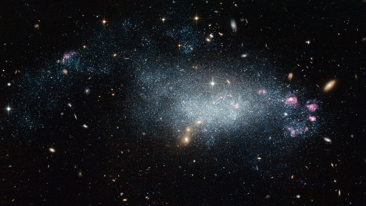 A spiral galaxy with clusters of bright stars and pink nebulae gives the space appearance an enchanting allure, set against a black background dotted with distant galaxies.