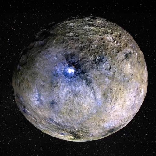 A cratered, spherical celestial body with a bright spot on its surface floats in dark outer space dotted with stars.