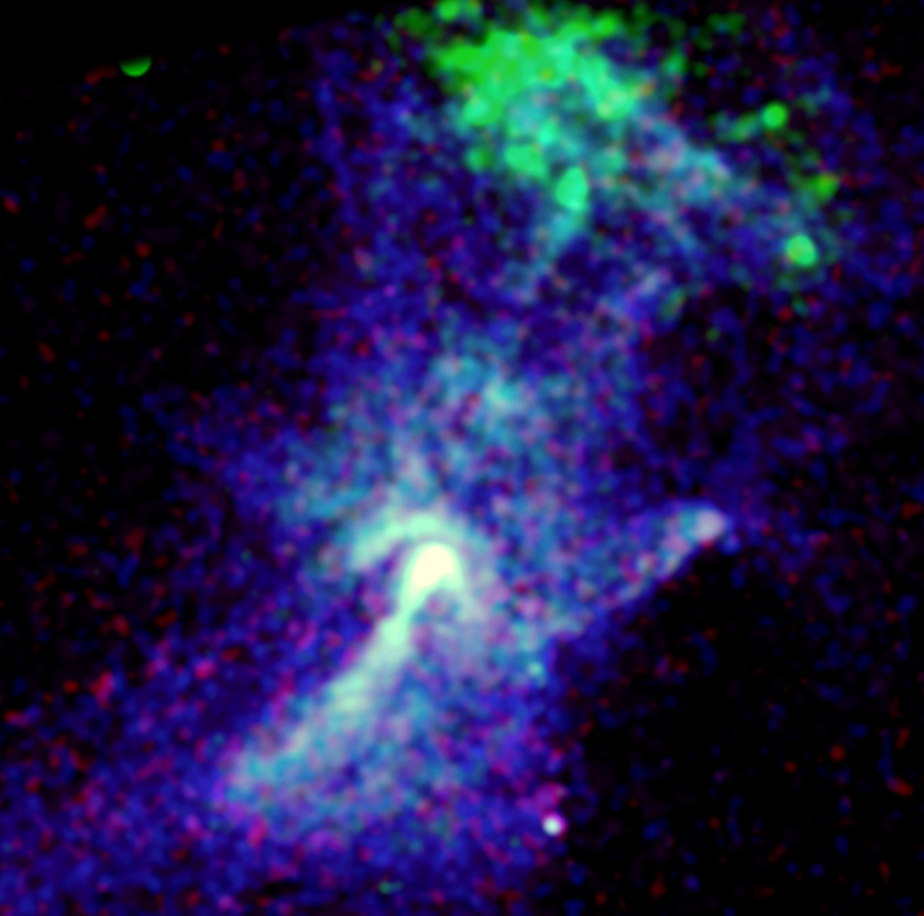 False-color astronomical image showing a cloud-like structure carved by a dead star, with bright blue and green regions, set against a dark background with scattered red and blue specks&mdash;evoking the famed "Hand of God" effect.