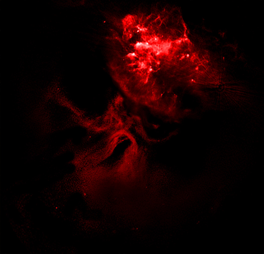 A red nebula-like cloud structure appears against a dark background, its glowing patterns resembling cosmic dust illuminated in space&mdash;shaped as if a dead star helped carve the Hand of God across the universe.