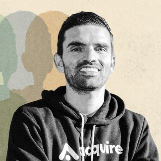 A man, identified as Andrew Gazdecki, wears a dark hoodie with “Acquire” printed on it, standing against a beige background with multi-colored shadows behind him.