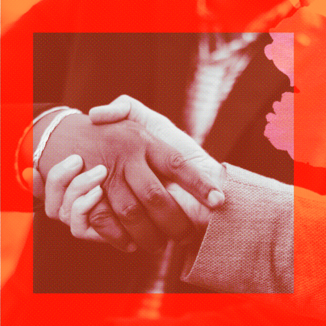 Two people wearing business attire shake hands, photographed close-up, with a red filter overlaying the image.