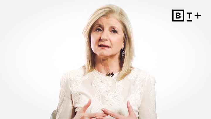 A woman with blonde hair wearing a white, patterned blouse speaks while gesturing with her hands; a "BT+" logo appears in the top right corner.